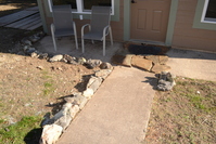 Trimed the walk with rocks from the yard.  It might keep back the mud when it rains.  Lots more rocks to bring up the hill to complete it!